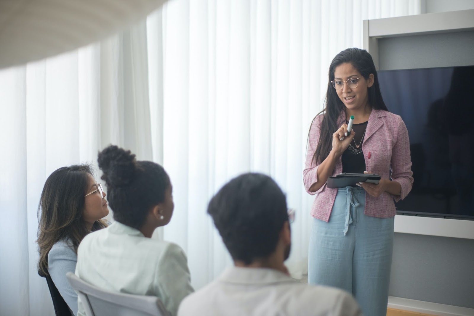 A group of employees listen intently to training.